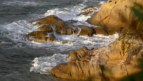 Sea-waves-crashing-on-rocks-during-sunset