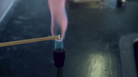 Close-up-of-blue-bunsen-burner-flame-followed-by-potassium-flame-test-burning-lilac