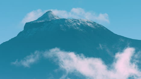 Extreme-long-lens-shot-of-the-top-of-Mount-Pico-with-clouds-foreground,-the-Azores