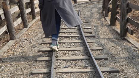 Nami-Island-closeup-woman-girl-walking-alone-the-railway-railroad