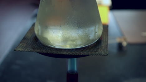 Close-up-of-Condensation-on-the-outside-of-an-Erlenmyer-Flask-that-is-being-heated-by-a-bunsen-burner
