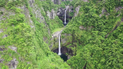 Aerial-zoom-out-from-one-of-the-Takamaka-waterfalls-on-the-Marsouins-River,-Reunion-Island