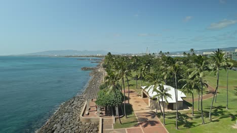 Aerial-view-of-Hawaiian-waterfront-tracking-forward-on-sunny-day