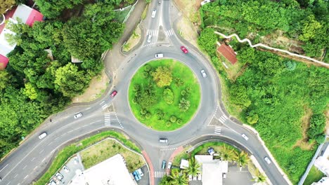 Aerial-view-looking-directly-down-on-a-roundabout-as-vehicles-travel-around-it