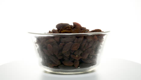 Dried-goji-berries-in-a-glass-bowl-rotating-on-a-white-background