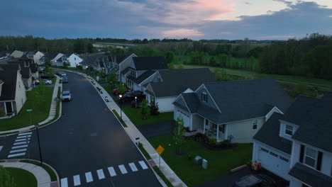 Fast-aerial-flight-displaying-beautiful-sunset-over-large-American-neighborhood
