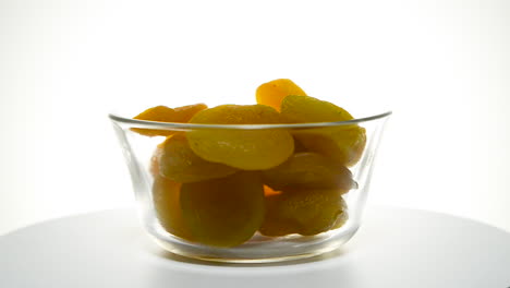 Glass-rotating-bowl-of-Turkish-apricot-rotating-isolated-on-white-background