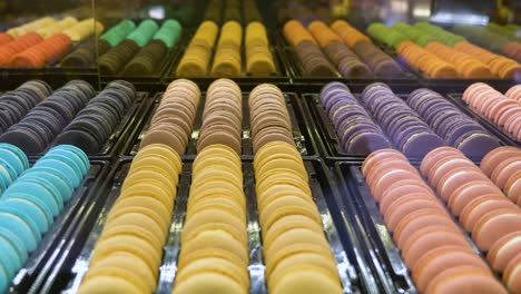 Colourful-window-display-or-rows-of-sweet-candy-macaroons-through-store-window