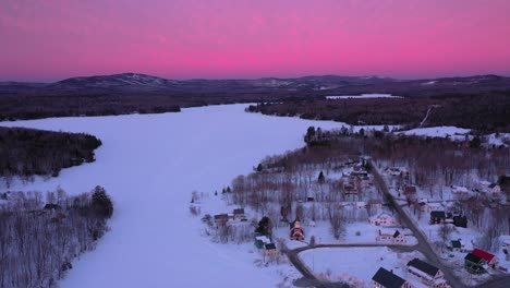 AERIAL-ORBIT-aound-a-small-town-on-the-shore-of-a-frozen-lake-during-an-amazing-sunrise