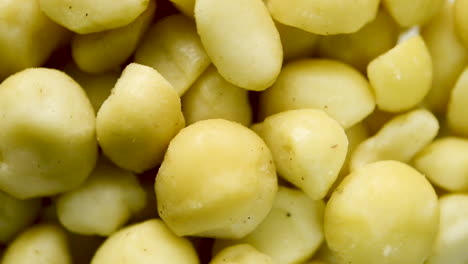 Close-up-on-rotating-portion-of-Macadamia-nuts,-uncooked-white-selection