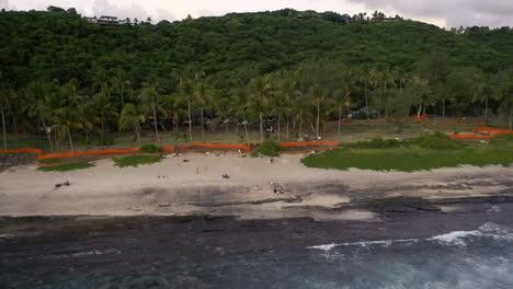 Drone-zooms-out-from-a-beach-to-show-view-over-the-Grand-Anse-area-of-Reunion-Island