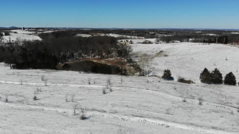 A-low-drone-flight-over-Midwest-USA-farmland-covered-in-snow