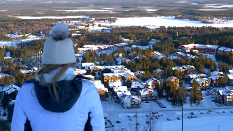 Ski-Girl-Overlooking-Ski-Resort-Town-Levi,-Finland