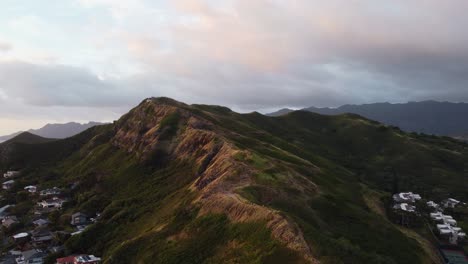 Cinematic-counterclockwise-crane-drone-shot-of-the-Lanikai-pillbox-trail-during-sunrise-in-Oahu
