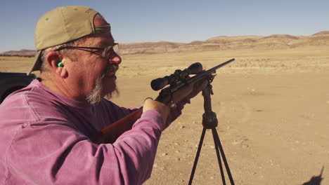 Practicing-Gun-Shooting-In-Desert-With-Rifle