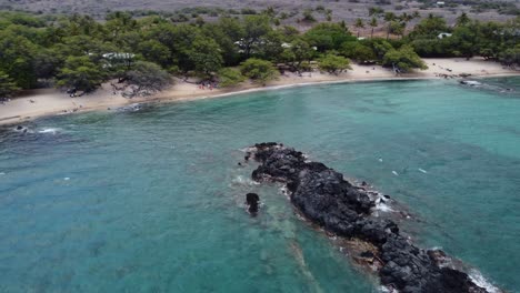 Cinematic-clockwise-drone-shot-of-a-lava-island-formed-in-the-water-at-Waialea-Beach-on-the-Big-Island-of-Hawaii