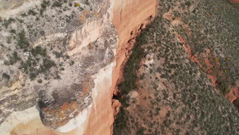 Aerial-view-of-the-edge-of-a-cliff-in-a-red-dessert-canyon-in-Teruel,-Spain