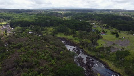 4K-cinematic-clockwise-drone-shot-of-a-river-flowing-through-a-tropical-jungle-near-Hilo-on-the-Big-Island-of-Hawaii