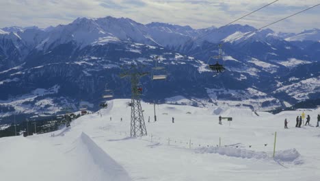 Crap-Sogn-Gion-chairlift-in-Laax,-Switzerland,-from-Caffe-Noname,-sunny-day-at-ski-resort