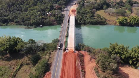 Aerial-view-of-bridge-in-duplication-phase-on-highway,-land-transport,-vehicles,-trucks