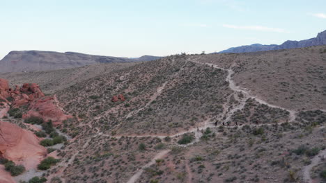 Wide-aerial-shot-of-hikers-on-trail-in-scenic-Southwest-desert-mountain-landscape