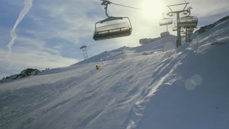Crap-Sogn-Gion-chairlift-skier-snowboarder-POV-sunny-Laax