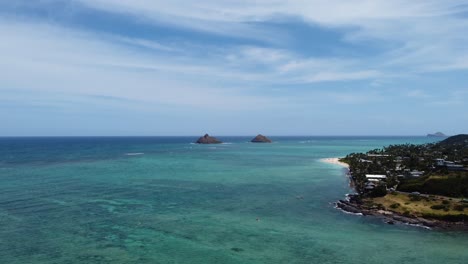4K-cinematic-zoom-out-drone-shot-of-two-islands-from-over-the-crystal-clear-ocean-at-Kailua-Beach-in-Oahu
