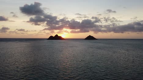 4K-cinematic-zoom-drone-shot-of-two-islands-and-the-sea-near-Lanikai-Beach-at-sunrise-on-the-Hawaiian-island-of-Oahu