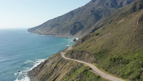 Aerial-view-of-Pacific-Coast-Highway-in-coastal-California-with-mountains-and-ocean