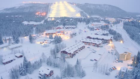 Drone-aerial-flyover-closeup-pulling-away-,-Levi,-Finland-village-snowy-neighborhood-with-police-incident-crash-on-road