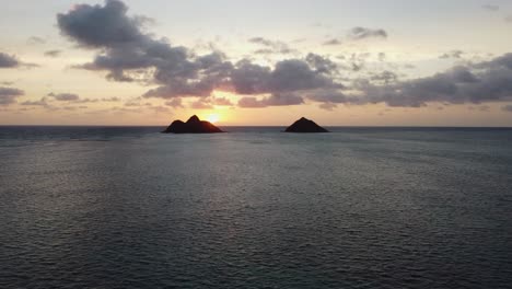 4K-cinematic-crane-zoom-drone-shot-of-early-sunrise-over-two-islands-and-the-ocean-near-Lanikai-Beach-in-Oahu