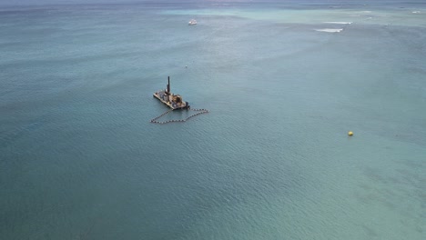 Aerial-view-of-barge-off-Waikiki-in-Pacific-ocean-on-sunny-day