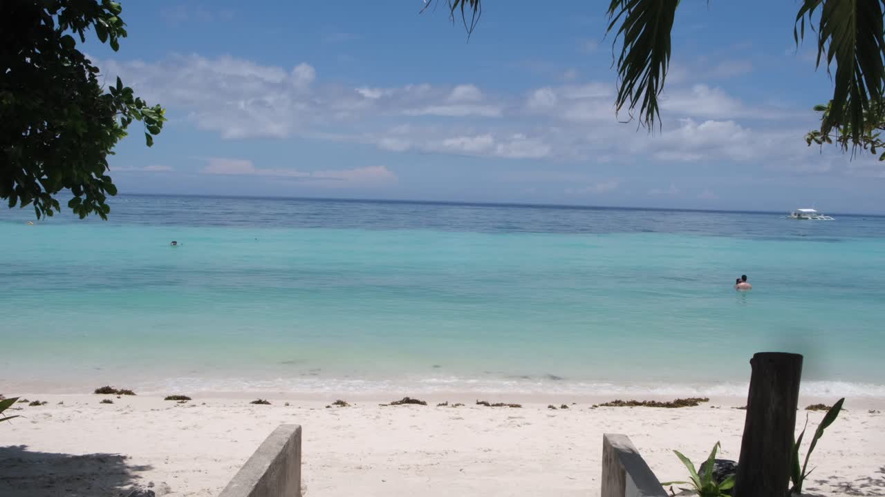 Caribbean blue water background on a white sand beach in Bohol