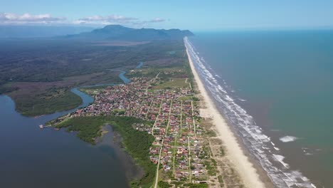 Aerial-view-of-fishing-villages,-freshwater-river-on-the-left-and-open-sea-on-the-right