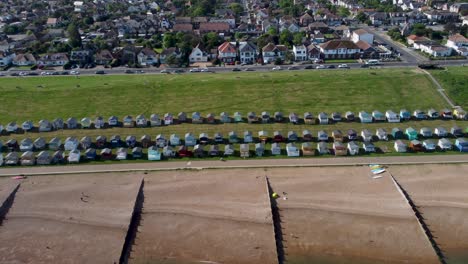 A-dolly-right-flyover-of-Tankerton-beach,-with-both-a-view-of-the-beach-houses-and-town
