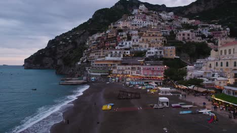 Twilight-drone-shot-over-popular-black-beach-of-Positano-on-Amalfi-Coast