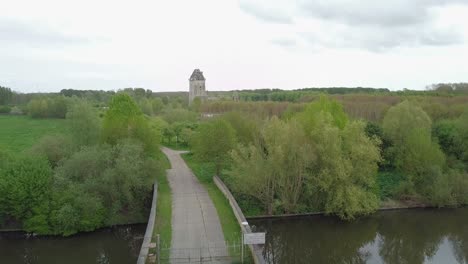 Aerial-drone-flying-forward-toward-the-modern-ruin-of-the-Castle-Almere,-Flevoland-the-Netherlands