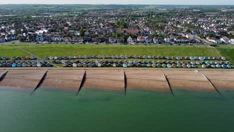 An-idyllic-dolly-forward-aerial-flyover-of-Tankerton-beach,-flying-towards-the-town