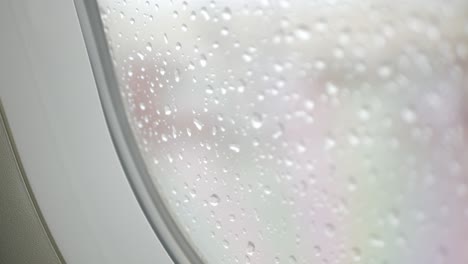 raindrop-on-the-window-surface-of-airplane-from-inside-cabin