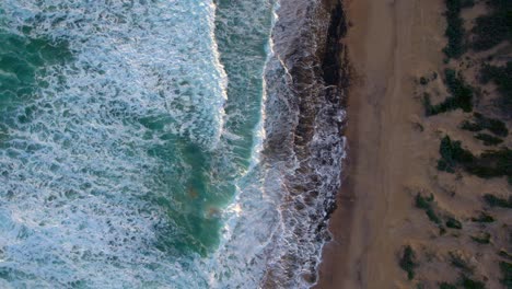 Vertical-drone-footage-moving-from-the-beach-to-the-ocrean,-at-Barwon-Heads,-Victoria,-Australia