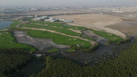 Top-view-of-Ajman-Mangroves-and-Golf-course-in-the-United-Arab-Emirates,-4k-Footage