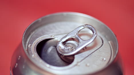 Open-aluminum-can-with-water-drops,-zoom-out-shot