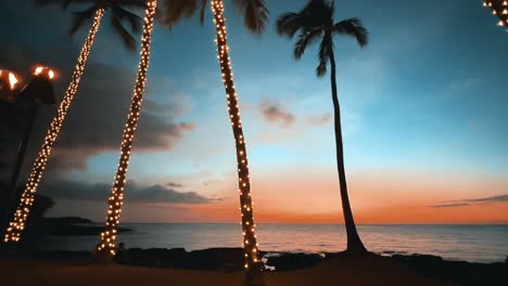 A-colorful-Hawaiian-sunset-with-decorative-holiday-lights-on-the-palm-trees-in-the-foreground---panorama