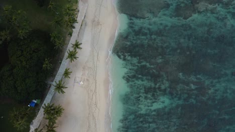 4K-cinematic-overhead-drone-shot-of-waves-crashing-on-Waikiki-Beach-in-Oahu-during-sunset