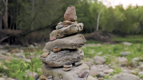Close-up-of-Inukshuk-Cairn-Stone-Rock-Pile-in-Forested-landscape