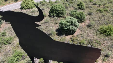 Aerial-view-of-the-Spanish-national-symbol-El-Toro-de-Osborne,-a-huge-metal-bull-on-the-top-of-a-hill