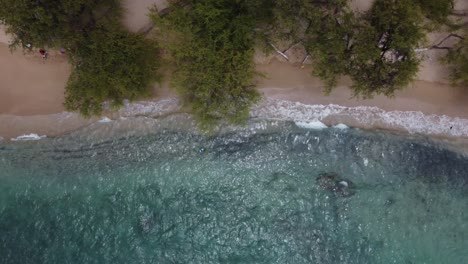 4K-cinematic-overhead-drone-shot-of-crystal-clear-waves-crashing-on-Waialea-Beach-near-Kona-on-the-Big-Island-of-Hawaii
