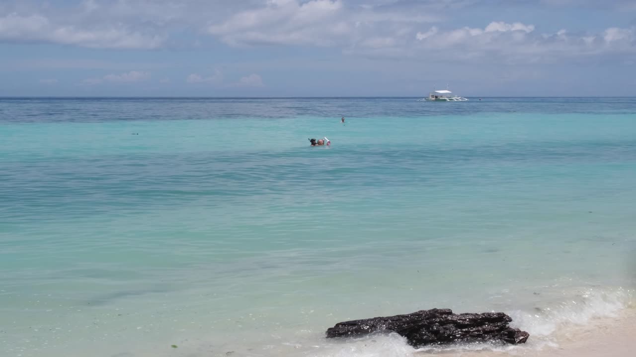 Caribbean blue water background on a white sand beach in Bohol