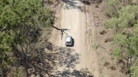 Isolated-car-driving-on-rural-road-at-St-Lawrence,-Clairview-in-Australia