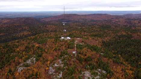 Drone-aerial-view-of-cellular-antenna-on-top-of-a-mountain